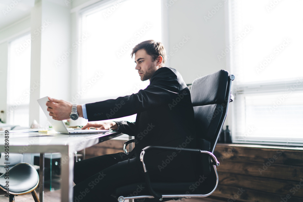 Serious businessman working at laptop Serious businessman working at laptop
