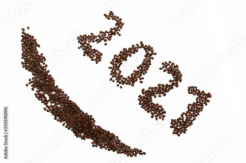 2021 and smile laid out from coffee beans on a white background. christmas coffee house concept