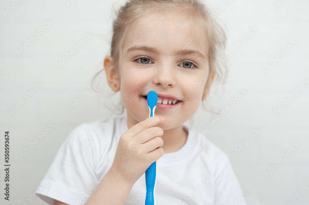 Little girl holds a toothbrush in her hands and toothpaste brushes Little girl holds a toothbrush in her hands and toothpaste brushes