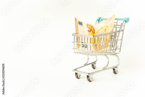 Small trolley with euro. Coronavirus crisis money stimulus policy, QE or money injection to aid economics and business to survive in COVID-19 outbreak
