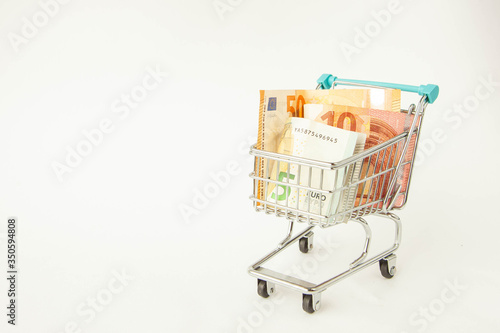 Small trolley with euro. Coronavirus crisis money stimulus policy, QE or money injection to aid economics and business to survive in COVID-19 outbreak 