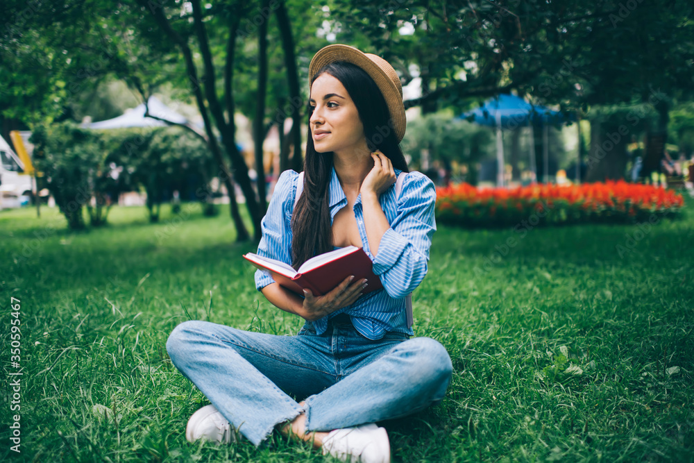 Young woman reading book in park