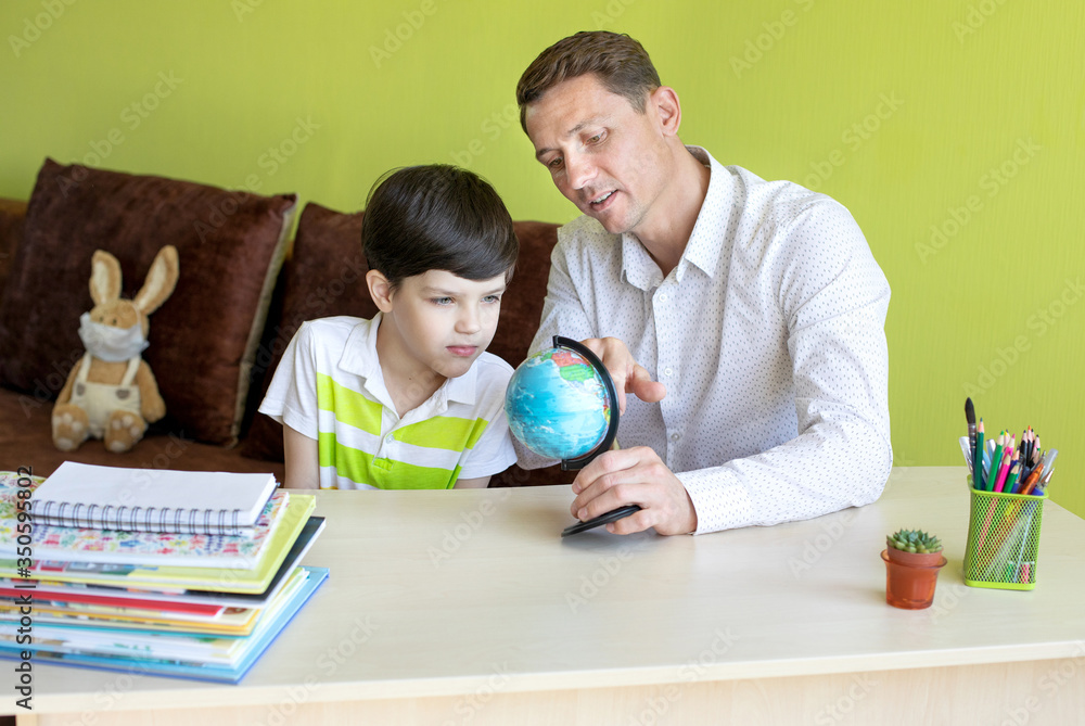 Boy with father doing homework during the coronavirus quarantine. Boy with father doing homework during the coronavirus quarantine.