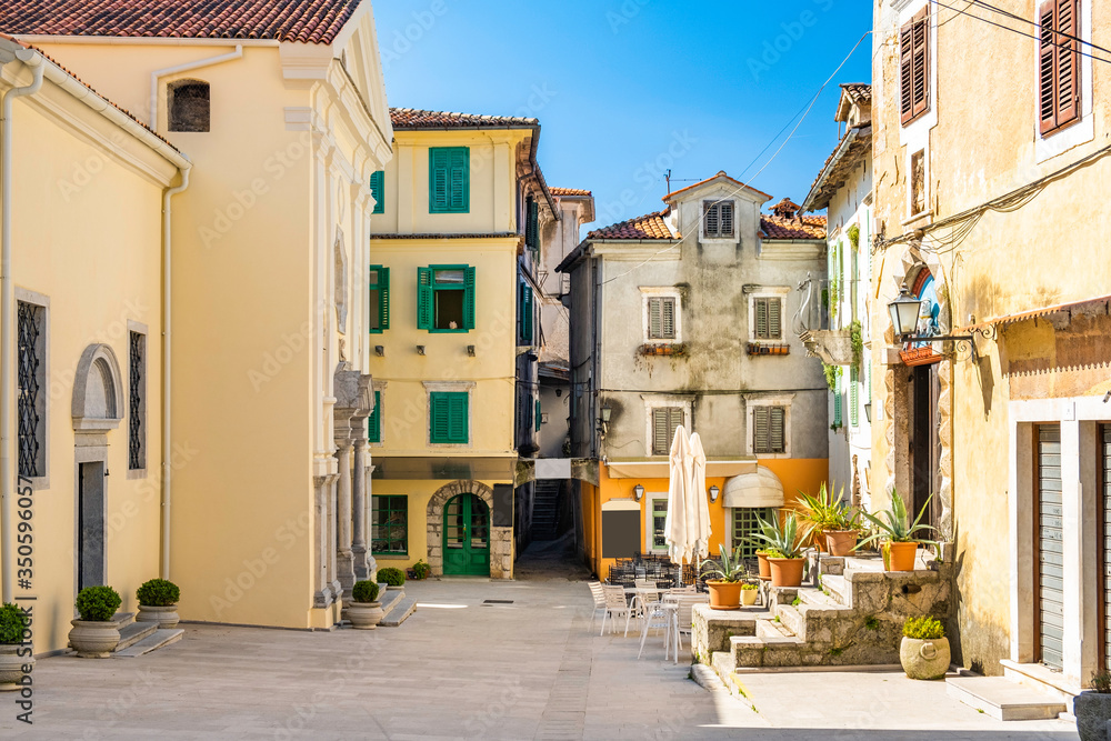 Croatia, town of Lovran. Central square in old town with classic buildings and old street cafes and restaurants