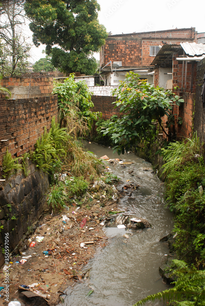 Recife / Pernambuco / Brazil. July, 31, 2015. Stream with garbage and dumping of construction debris in Bomba do Hemetério, a neighborhood on the outskirts of Recife. Recife / Pernambuco / Brazil. July, 31, 2015. Stream with garbage and dumping of construction debris in Bomba do Hemetério, a neighborhood on the outskirts of Recife.
