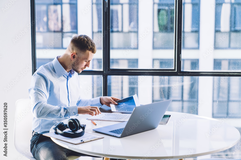 Focused businessman reviewing report at work Focused businessman reviewing report at work