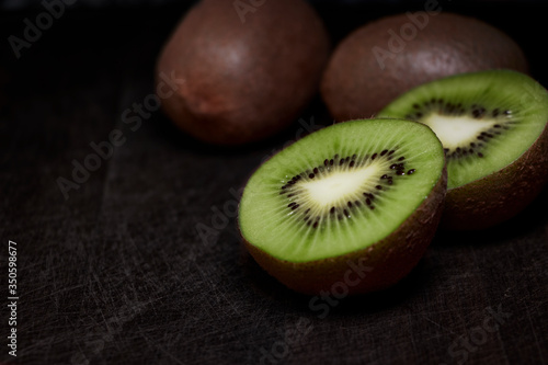 kiwi cut with dark wooden background