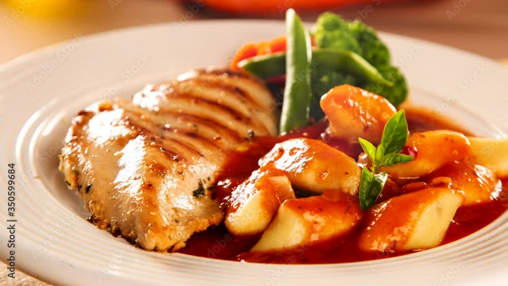 Slide shot Delicious healthy food with grilled meat, gnocchi potato, red sauce and broccoli on the plate. Slide shot Delicious healthy food with grilled meat, gnocchi potato, red sauce and broccoli on the plate.