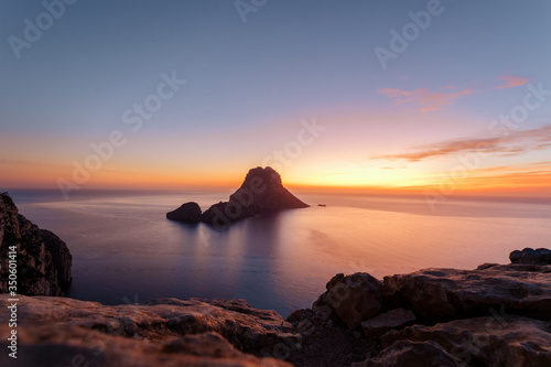 Es Vedra at the sunset, pastel colored sky at the mystic rock of Es Vedra, Ibiza Island.
