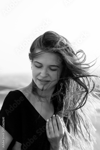 Portrait of a beautiful young girl in the desert. Portrait of a beautiful young girl in the desert. A closeup. Black and white image.
