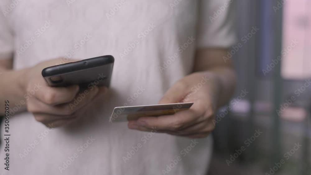 Online shopping concept. Young woman filling and paying order in online store application. Close-up view of unrecognizable female purchasing clothes online Online shopping concept. Young woman filling and paying order in online store application. Close-up view of unrecognizable female purchasing clothes online