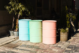 Multicolored tin barrels near the cafe