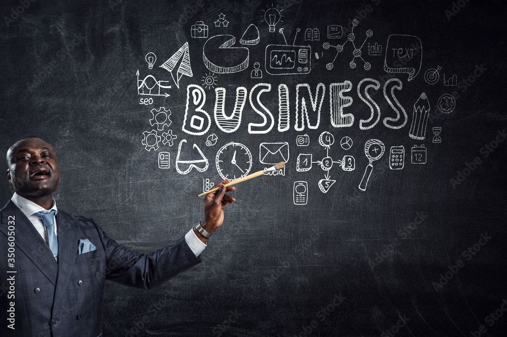 Conceptual image of ambitious and creative businessman in black suit holding paintbrush in hand Conceptual image of ambitious and creative businessman in black suit holding paintbrush in hand