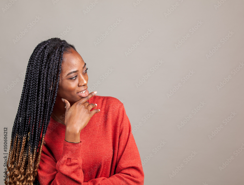 X Happy, positive African American female in red color shirt on gray background. X Happy, positive African American female in red color shirt on gray background.