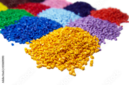 Fotografie Multi colored plastic polymer granules isolated on white