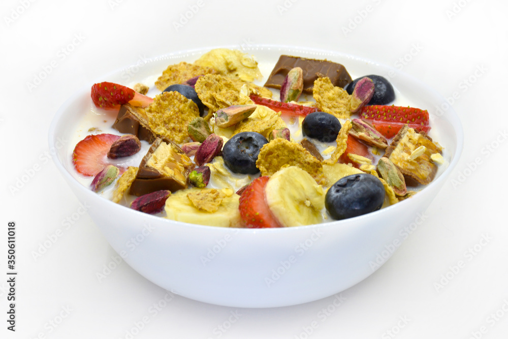 Corn flakes with fresh Fruit, Pistachio and chocolate in bowl, isolated on white background Corn flakes with fresh Fruit, Pistachio and chocolate in bowl, isolated on white background