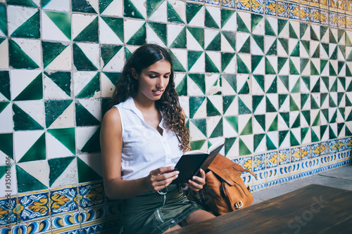 Photography Young woman reading book in cafe