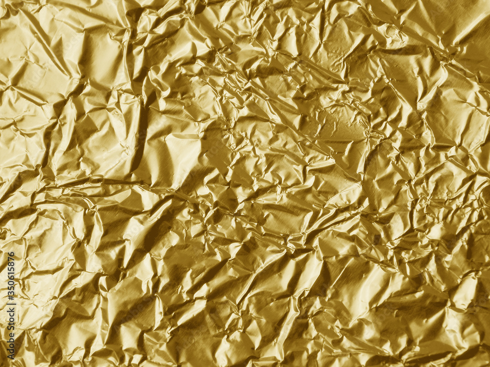 Crumpled metallic gold foil texture background Crumpled metallic gold foil texture background