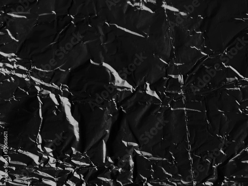 Wrinkled black foil texture background