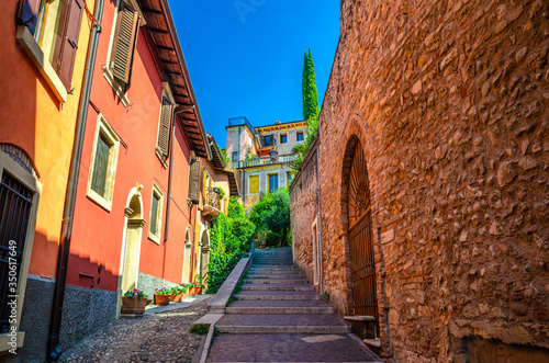 Staircase stairway of narrow street between stone walls. Scalinata Castel S. Pietro leading to Castel San Pietro in Verona city historical centre, blue sky background, Veneto Region, Northern Italy photo