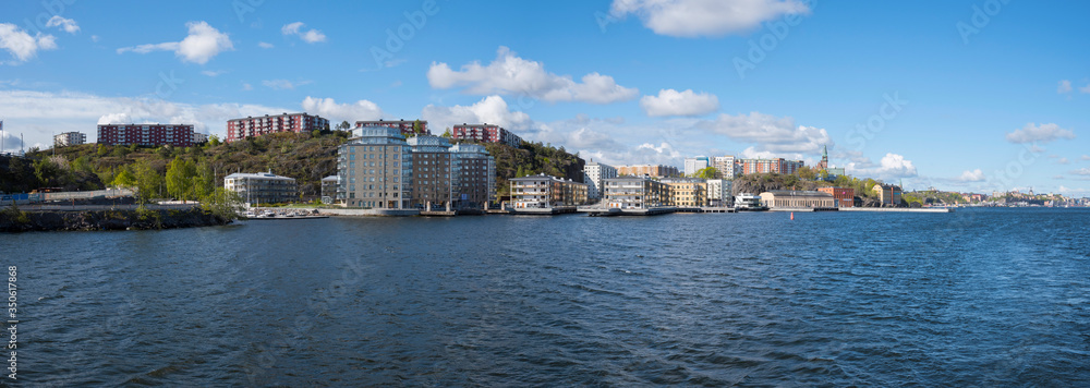 View over the Nybroviken bay with boats and old houses on the island Blasieholmen and the old town Gamla Stan in Stockholm