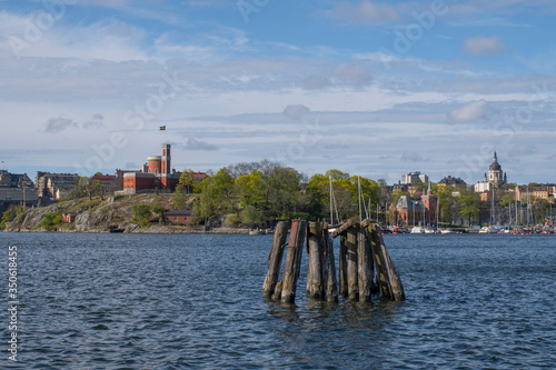 Dolphin, bollard in the bay Nybroviken in Stockholm with boats a sunny spring day.  photo