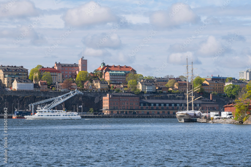 Harbor view with boats and ships at the district Södermalm a sunny spring morning in Stockholm. 