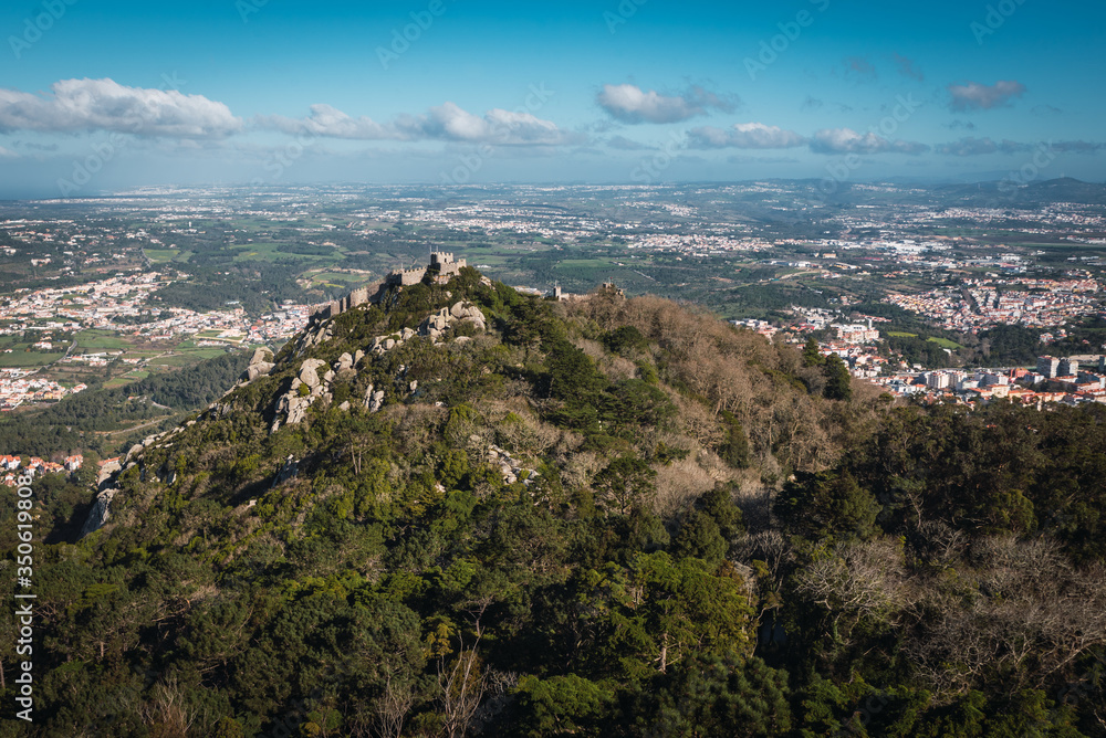Castelo dos Mouros on mountain full of vegetation in day with clouds