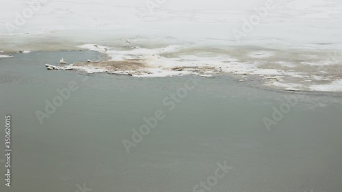 Wallpaper Mural Flowing water on a background of ice. Spring river timelapse Torontodigital.ca