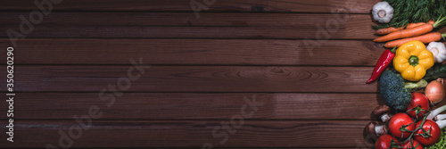 Banner from various vegetables and fruits isolated on dark background rustic table, top view, creative flat layout. Concept of healthy eating, food background. Frame of vegetables with space for text.