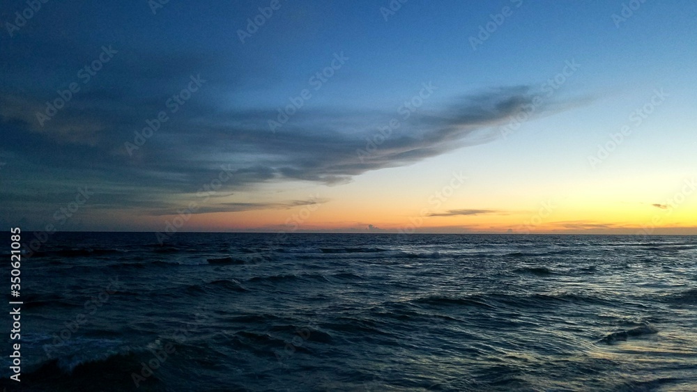 Scenic View Of Sea Against Sky At Dusk