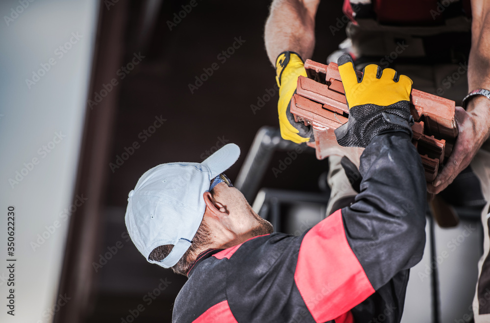 Fototapeta premium Male Contractors Unloading Ceramic Roof Tile.