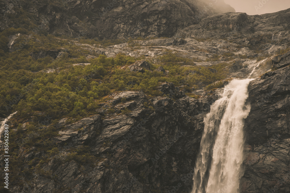 Waterfall And Rocks Landscape Of Norway.