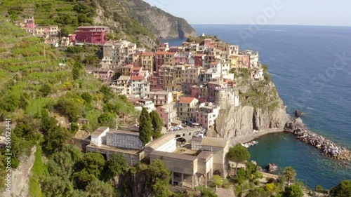 Wallpaper Mural Aerial shot of houses in coastal city on sunny day, drone panning over buildings on rocky cliff - Cinque Terre, Italy Torontodigital.ca