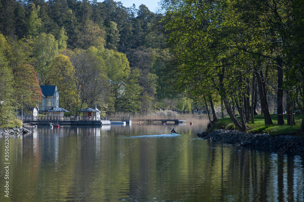 Fototapeta premium Landscape view at the waterfront of the lake Lännerstasundet and Stockviken i the district Nacka of Stockholm a sunny spring morning.