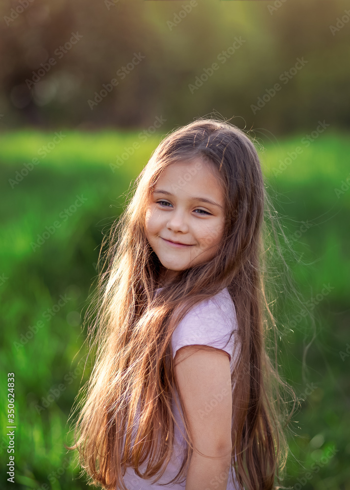 portrait of a little girl with long hair on summer nature portrait of a little girl with long hair on summer nature
