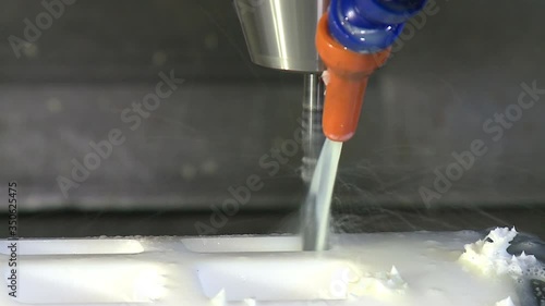 worker manages a metal working machine working on industry machine