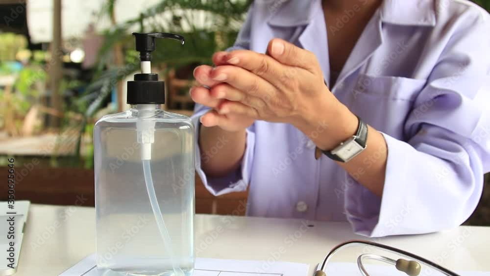 female doctor is cleaning the hands to prevent the infection of Covid 19 female doctor is cleaning the hands to prevent the infection of Covid 19