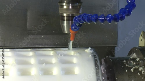 worker manages a metal working machine working on industry machine