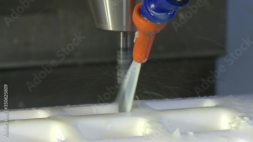 worker manages a metal working machine working on industry machine