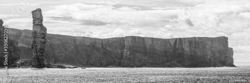 black and white panorama of Old Man of Hoy, a tall sandstone stack at the coast between Stromness and Scrabster at Orknay in Scotland, Uk