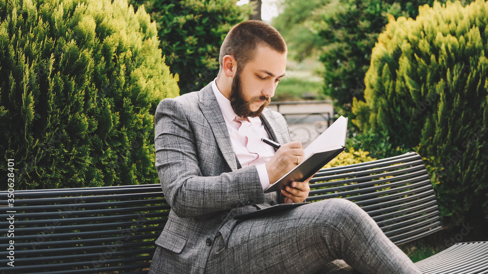 Fototapeta premium Businessman is calculating something in tablet