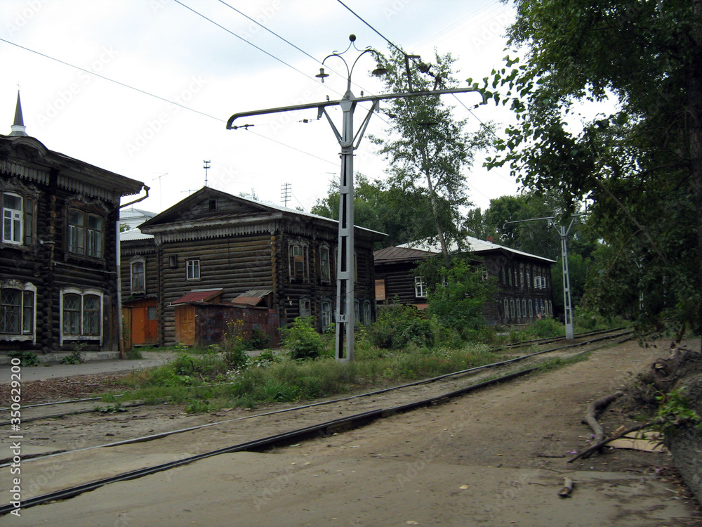 Wooden buildings and a tram track in the 414 year old Siberian city of Tomsk in Russia