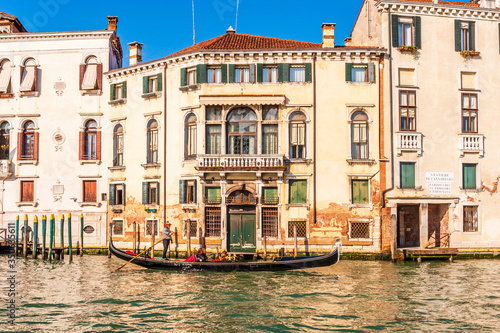 Medieval facades on the Grand Canal and a gondola in Venice in Veneto, Italy