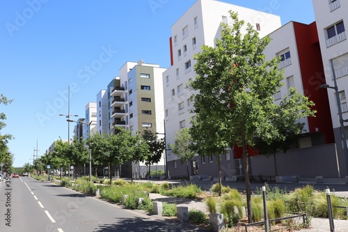 Fototapeta Naklejka Na Ścianę i Meble -  La rue Rosa Parks bordée d'immeubles modernes d'habitation dans le quartier de la Duchère à Lyon - Ville de Lyon - 9 ème arrondissement - Département du Rhône - France