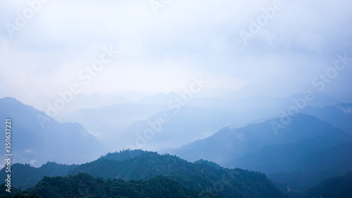Beautiful glorious colourful sunrise in the national park over the mountains in China  mysterious landscape with hills  clouds  mist and colour shades  trekking and hiking outdoors  peak summit 
