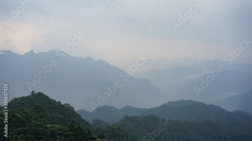 Beautiful glorious colourful sunrise in the national park over the mountains in China, mysterious landscape with hills, clouds, mist and colour shades, trekking and hiking outdoors, peak summit 