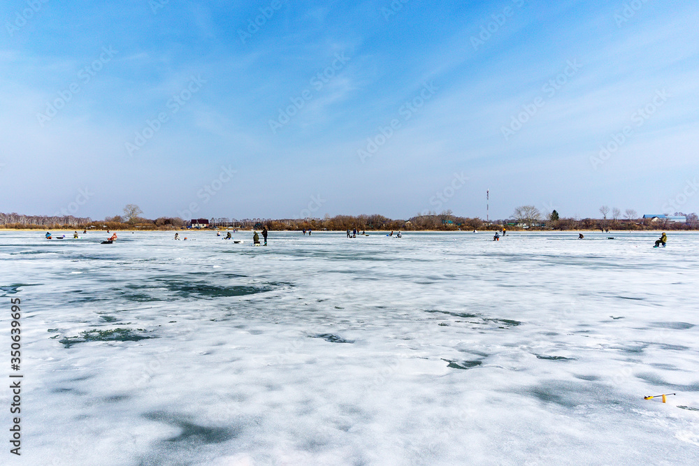 natural winter background, a fisherman on the ice. fishing in the winter, the place for copyspace