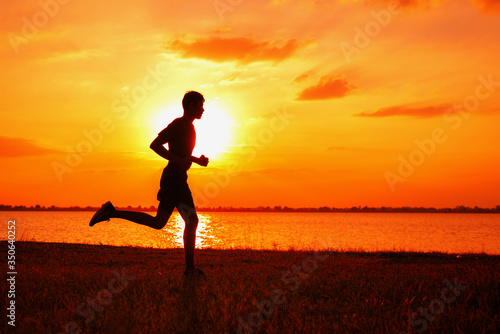 Fototapeta Naklejka Na Ścianę i Meble -  Athlete runner feet running on road, Jogging at outdoors. Man running for exercise.Sports and healthy lifestyle concept.
