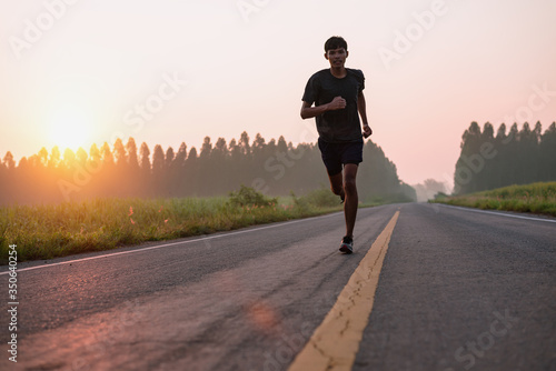 Athlete runner feet running on road  Jogging at outdoors. Man running for exercise.Sports and healthy lifestyle concept.